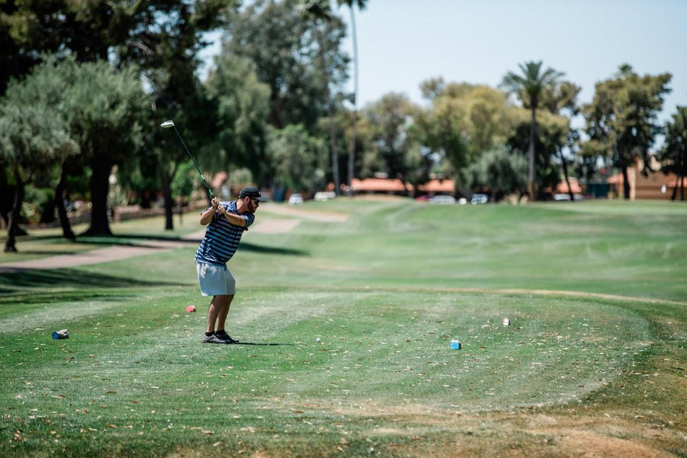 a person plays golf on a golf course